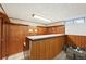 Basement bar area with natural wood panelling, perfect for entertaining at 3540 E 90Th Pl, Thornton, CO 80229