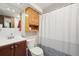 Cozy full bathroom with a shower/tub combo and storage options at 3540 E 90Th Pl, Thornton, CO 80229