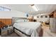 Basement bedroom area with a queen size bed and soft accent colors at 3540 E 90Th Pl, Thornton, CO 80229