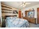 Bedroom with a large window allowing in natural light, decorative shelving and vintage furniture at 3540 E 90Th Pl, Thornton, CO 80229