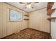 Small bedroom with a window for natural light, neutral wallpaper, and vintage open storage shelving at 3540 E 90Th Pl, Thornton, CO 80229