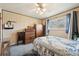Bedroom showcasing a comfortable bed, vintage furniture, and bright natural light at 3540 E 90Th Pl, Thornton, CO 80229