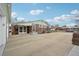 Exterior shot of house shows large driveway, partial brick facade, and garage at 3540 E 90Th Pl, Thornton, CO 80229