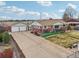 Aerial view of home showing brick facade, spacious drive way, and well manicured yard at 3540 E 90Th Pl, Thornton, CO 80229