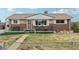 Charming brick home with a cozy front porch and well-maintained front lawn at 3540 E 90Th Pl, Thornton, CO 80229