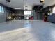 Spacious two car garage with gray epoxy floors, cabinets, and work area at 3540 E 90Th Pl, Thornton, CO 80229