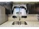 Close-up of a stylish kitchen sink with marble countertops and decorative window accents at 3540 E 90Th Pl, Thornton, CO 80229