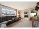 Comfortable living room featuring a large window, plush seating, and warm lighting at 3540 E 90Th Pl, Thornton, CO 80229