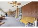 Open sun room with brick wall features an array of decorations and furniture with a view to the back yard at 3540 E 90Th Pl, Thornton, CO 80229