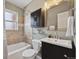 Cozy bathroom with tub, shower, dark wood vanity and traditional fixtures at 1610 Trenton St, Denver, CO 80220