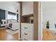 Cozy bedroom featuring hardwood floors, ceiling fan, and an ensuite bathroom at 1610 Trenton St, Denver, CO 80220