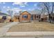 Charming brick home with a well-manicured front yard and attached garage at 1610 Trenton St, Denver, CO 80220