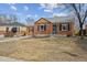 Charming brick home with a well-manicured front yard and attached garage at 1610 Trenton St, Denver, CO 80220