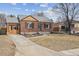 Charming brick home with a well-manicured front yard and attached garage at 1610 Trenton St, Denver, CO 80220