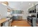Stylish kitchen featuring stainless steel appliances, subway tile, and modern finishes at 1610 Trenton St, Denver, CO 80220