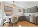 Bright eat-in kitchen with stainless appliances, modern finishes, and wood floors at 1610 Trenton St, Denver, CO 80220