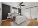 Stylish bedroom with modern ceiling fan, barn door, and hardwood floors at 1610 Trenton St, Denver, CO 80220