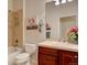 Bathroom with cherry cabinets, tiled shower, and framed mirrors at 4971 Bross Pl, Broomfield, CO 80023