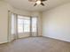 Large bedroom with ceiling fan, neutral carpet, and large windows at 4971 Bross Pl, Broomfield, CO 80023