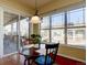 Bright breakfast nook with large windows and views of the backyard at 4971 Bross Pl, Broomfield, CO 80023