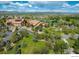 Aerial view of the community clubhouse with beautifully landscaped grounds, pond, and mountain backdrop at 4971 Bross Pl, Broomfield, CO 80023