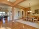 Open-concept dining room with hardwood floors and stylish chandelier lighting at 4971 Bross Pl, Broomfield, CO 80023