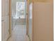 Hallway with tiled floors, a closet, and a view of the laundry room at 4971 Bross Pl, Broomfield, CO 80023