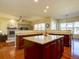 Open concept kitchen with a central island and hardwood floors at 4971 Bross Pl, Broomfield, CO 80023