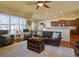 Open-concept living room with a view of the kitchen and large windows at 4971 Bross Pl, Broomfield, CO 80023