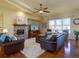 Warm and inviting living room with a stone fireplace and hardwood floors at 4971 Bross Pl, Broomfield, CO 80023