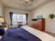 Charming main bedroom featuring a tray ceiling, ceiling fan, and large window at 4971 Bross Pl, Broomfield, CO 80023