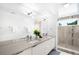 This contemporary bathroom offers double sinks with modern fixtures and a glass door shower at 2242 W 34Th Ave, Denver, CO 80211