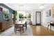 Open dining room features wood floors, sideboard, light fixture, and a large window at 2242 W 34Th Ave, Denver, CO 80211