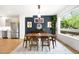 Bright dining room with modern light fixture, rug, and large window with outdoor views at 2242 W 34Th Ave, Denver, CO 80211
