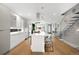 Open kitchen with seating at the island, stainless appliances and view into the staircase and living room at 2242 W 34Th Ave, Denver, CO 80211