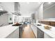 Bright kitchen features stainless appliances, gas range, modern cabinets, and a view to the living area at 2242 W 34Th Ave, Denver, CO 80211
