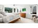 Bright main bedroom features a large window, ceiling fan, wooden dresser and modern decor at 2242 W 34Th Ave, Denver, CO 80211
