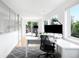 Sun-filled home office features a large monitor and sliding doors to an outdoor deck at 2242 W 34Th Ave, Denver, CO 80211