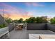 Sunset view from the rooftop deck with dining, seating, and space to entertain guests at 2242 W 34Th Ave, Denver, CO 80211