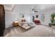 Primary bedroom with a ceiling fan, cozy seating, and two windows with natural light at 6435 S Dayton St # 103, Englewood, CO 80111