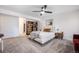 A spacious bedroom with a door leading to a walk in closet and ensuite at 6435 S Dayton St # 103, Englewood, CO 80111