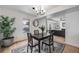 Bright dining room with a modern table set, decor and living area in background at 6435 S Dayton St # 103, Englewood, CO 80111