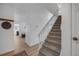 Bright entryway featuring a staircase, hat rack, and wood-look floors, creating a welcoming space at 6435 S Dayton St # 103, Englewood, CO 80111