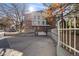 Multi-story condo building with brick facade, upper-level patios, and gated entry to the parking area at 6435 S Dayton St # 103, Englewood, CO 80111