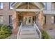 Inviting front entrance of a brick building with stone accents and prominent numbering at 6435 S Dayton St # 103, Englewood, CO 80111