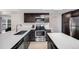 Modern kitchen with stainless steel appliances, sleek cabinets, and quartz counters at 6435 S Dayton St # 103, Englewood, CO 80111