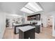 Modern kitchen boasts sleek black cabinetry, an island, stainless appliances and ample lighting at 6435 S Dayton St # 103, Englewood, CO 80111