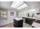 Well-lit kitchen featuring a center island, stainless steel appliances and wood flooring at 6435 S Dayton St # 103, Englewood, CO 80111