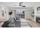 Cozy living room with a comfortable gray couch, fireplace, and sliding door access to a balcony at 6435 S Dayton St # 103, Englewood, CO 80111