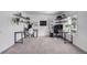Bright home office featuring two workstations with floating shelves and natural light at 6435 S Dayton St # 103, Englewood, CO 80111
